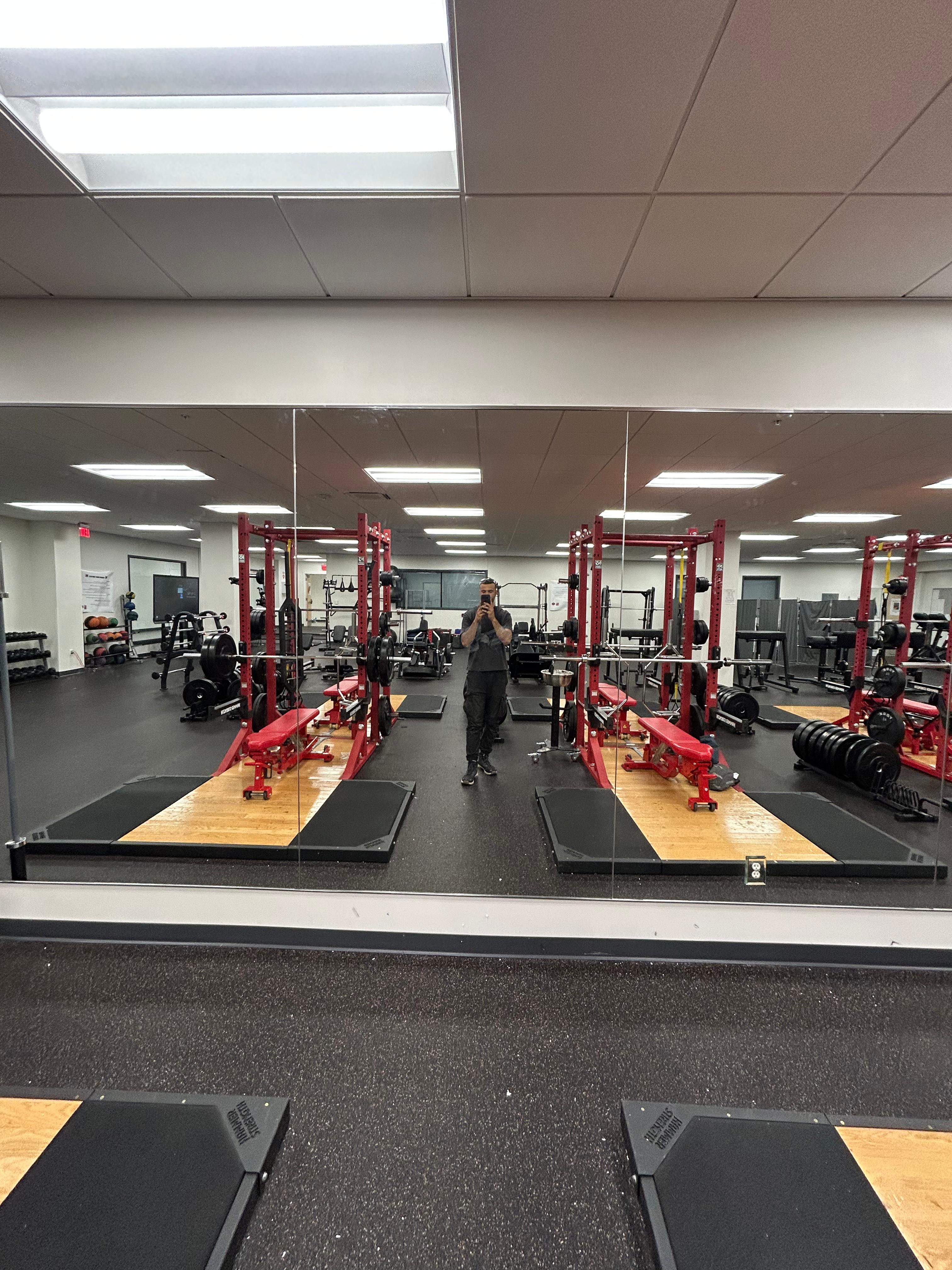 Large wall mirror installation in commercial gym